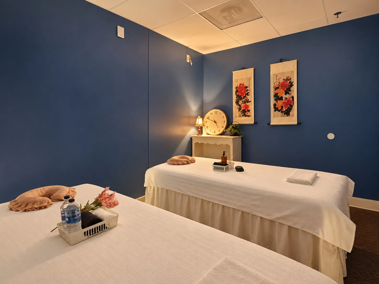 Couples massage room at our Gainesville massage spa, with two tables side by side under warm lamplight